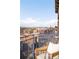 Balcony view offering a picturesque view of the city skyline and distant mountains with sunshine coming through the railings at 1925 W 32Nd Ave # 502, Denver, CO 80211