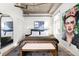 Modern bedroom with a gray rug, platform bed, concrete ceiling, and striking artwork at 1925 W 32Nd Ave # 502, Denver, CO 80211