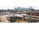 Stunning cityscape view from a high-rise balcony with sleek railings and comfortable outdoor furniture at 1925 W 32Nd Ave # 502, Denver, CO 80211