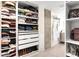 Well-organized walk-in closet with shelving, drawers, and hanging space, adjacent to the bathroom at 1925 W 32Nd Ave # 502, Denver, CO 80211