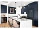 Modern kitchen with a spacious island, stylish pendant lights, and stainless steel appliances at 1925 W 32Nd Ave # 502, Denver, CO 80211