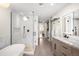 Modern main bathroom featuring a walk-in shower, soaker tub, dual vanity, and sleek design at 1925 W 32Nd Ave # 502, Denver, CO 80211