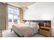 Serene main bedroom with balcony access, features a plush bed, stylish nightstands, and modern light fixture at 1925 W 32Nd Ave # 502, Denver, CO 80211