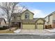 Two-story house with a green facade, two-car garage, and well-maintained lawn at 10463 Adams St, Northglenn, CO 80233