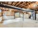 Unfinished basement featuring exposed wooden beams, concrete walls, and a concrete floor at 4780 W 102Nd Pl, Westminster, CO 80031