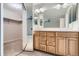 Well-lit bathroom featuring double vanity with wooden cabinets and a separate closet at 4780 W 102Nd Pl, Westminster, CO 80031