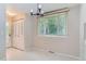 Bright dining space features white floors, stylish lighting, and a window offering outdoor views, perfect for Gathering meals at 4780 W 102Nd Pl, Westminster, CO 80031