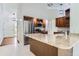 Well-lit kitchen featuring a stainless steel refrigerator, wooden cabinetry, and a speckled granite countertop at 4780 W 102Nd Pl, Westminster, CO 80031