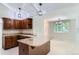 Updated kitchen features granite countertops, stainless steel appliances, wood cabinetry, and modern pendant lighting at 4780 W 102Nd Pl, Westminster, CO 80031