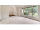 Bright living room with large picture windows offering abundant natural light and neutral carpeting at 4780 W 102Nd Pl, Westminster, CO 80031