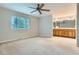 Spacious main bedroom featuring carpet, a ceiling fan, and an attached bathroom with dual sinks at 4780 W 102Nd Pl, Westminster, CO 80031