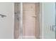 Modern shower stall featuring decorative tile work, glass doors, and updated shower fixtures at 4780 W 102Nd Pl, Westminster, CO 80031
