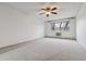 Spacious bedroom includes ceiling fan, large window, and neutral carpet at 350 S Clinton St # 9C, Denver, CO 80247