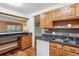 Functional kitchen with granite countertops, wooden cabinets, and an open layout at 350 S Clinton St # 9C, Denver, CO 80247