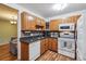Functional kitchen with wooden cabinets, granite countertops, and modern appliances at 350 S Clinton St # 9C, Denver, CO 80247