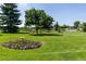 Well-maintained landscaped area with a flower garden and grassy lawn at 350 S Clinton St # 9C, Denver, CO 80247
