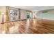 Bright living room boasts shiny hardwood floors, large windows, and sliding glass doors to a covered porch at 350 S Clinton St # 9C, Denver, CO 80247