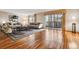 Spacious living room with wood floors, neutral decor, large windows, and sliding glass door to the balcony at 350 S Clinton St # 9C, Denver, CO 80247