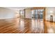 Bright living room with hardwood floors, large windows, and sliding doors to a private balcony at 350 S Clinton St # 9C, Denver, CO 80247