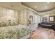 The bedroom features hardwood floors, trey ceilings, natural light, and comfortable furniture at 12380 Jasper Pointe Way, Castle Pines, CO 80108