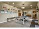 Spacious game room with a ping pong table, a chandelier, and comfortable seating area at 12380 Jasper Pointe Way, Castle Pines, CO 80108