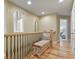 Upstairs hallway with wood floors and a decorative bench at 12380 Jasper Pointe Way, Castle Pines, CO 80108