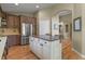 Open kitchen featuring a large island, stainless steel appliances, and hardwood floors at 12380 Jasper Pointe Way, Castle Pines, CO 80108