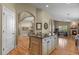 Bright kitchen with an island, hardwood floors, and open access to dining area at 12380 Jasper Pointe Way, Castle Pines, CO 80108