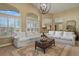 Spacious living room featuring comfortable seating, natural light, and open layout at 12380 Jasper Pointe Way, Castle Pines, CO 80108