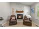 Living room with a white stone fireplace and two leather recliners at 12380 Jasper Pointe Way, Castle Pines, CO 80108