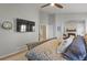 Neutral-toned main bedroom with a large screen TV and fireplace at 12380 Jasper Pointe Way, Castle Pines, CO 80108
