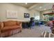 A comfortable office features desk space, an upholstered couch, and natural light from a window at 12380 Jasper Pointe Way, Castle Pines, CO 80108