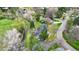 Aerial shot of a home surrounded by lush greenery and a creek running alongside the property at 1930 Taft Dr, Lakewood, CO 80215