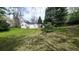 Sprawling backyard with a view of the house surrounded by lush green trees at 1930 Taft Dr, Lakewood, CO 80215