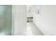 All white bathroom has a shower and a small vanity with a stool at 1930 Taft Dr, Lakewood, CO 80215