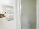 View from bathroom to bedroom with plush bed and window with lace valance at 1930 Taft Dr, Lakewood, CO 80215