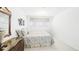 Well-lit bedroom featuring a bed, decorative artwork, and a wooden dresser at 1930 Taft Dr, Lakewood, CO 80215