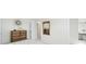 Bedroom features a wooden dresser, a decorative mirror, and a striking starburst clock on the wall at 1930 Taft Dr, Lakewood, CO 80215