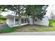 Carport with mature trees and lush greenery at 1930 Taft Dr, Lakewood, CO 80215