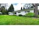 Charming white home with well-maintained lawn and mature landscaping at 1930 Taft Dr, Lakewood, CO 80215