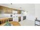A classic kitchen with wooden cabinets, white appliances, and a cozy breakfast nook at 1930 Taft Dr, Lakewood, CO 80215