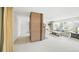Bright living room featuring a brick fireplace, large window, and plush carpeting at 1930 Taft Dr, Lakewood, CO 80215