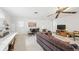 A cozy living room features a patterned sofa, piano, and built-in shelving at 1930 Taft Dr, Lakewood, CO 80215
