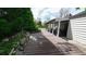View of a long patio attached to a house, surrounded by a yard and trees at 1930 Taft Dr, Lakewood, CO 80215