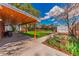 Large, covered patio with outdoor furniture overlooking manicured backyard and garden at 2274 S Cherry St, Denver, CO 80222