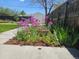 Backyard garden featuring purple allium flowers and a concrete sidewalk at 2274 S Cherry St, Denver, CO 80222