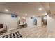 Finished basement with light wood floors, neutral walls, and access to stairs at 2274 S Cherry St, Denver, CO 80222