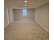 Bright basement features neutral walls and carpet and a window allowing for natural light at 2274 S Cherry St, Denver, CO 80222
