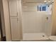 Bathroom boasts a walk-in shower with light tile, and a white storage cabinet for ample space at 2274 S Cherry St, Denver, CO 80222