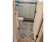 Modern bathroom featuring decorative black and white patterned tile floor and tiled shower with glass door at 2274 S Cherry St, Denver, CO 80222